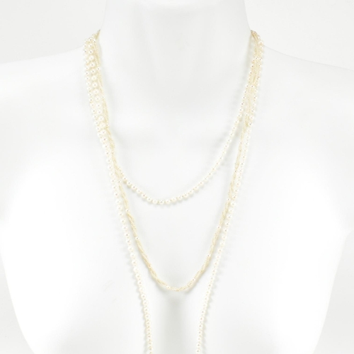 64 - Two pearl necklaces. A seed pearl necklace formed with triple twisted strings of seed pearls with pe... 