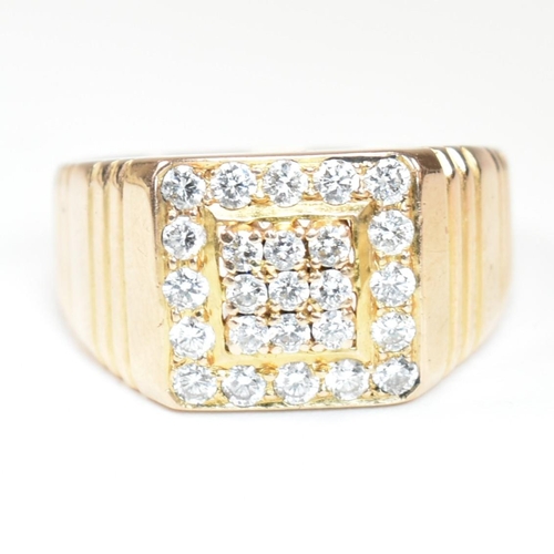 66 - A hallmarked 18ct gold and diamond signet ring. The ring having a square face set with nine round cu... 