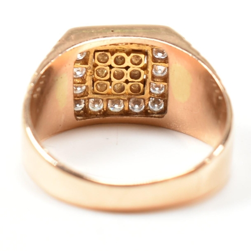 66 - A hallmarked 18ct gold and diamond signet ring. The ring having a square face set with nine round cu... 