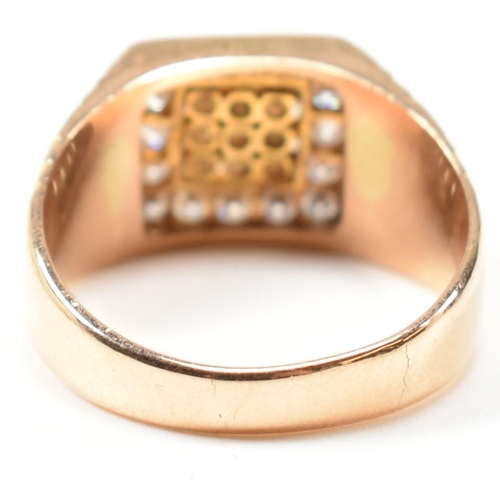 66 - A hallmarked 18ct gold and diamond signet ring. The ring having a square face set with nine round cu... 