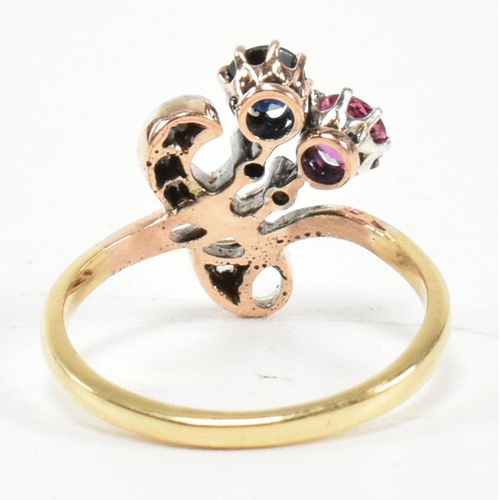 67 - An Art Nouveau ruby, sapphire and diamond ring. The ring having a round mixed cut ruby and sapphire ... 