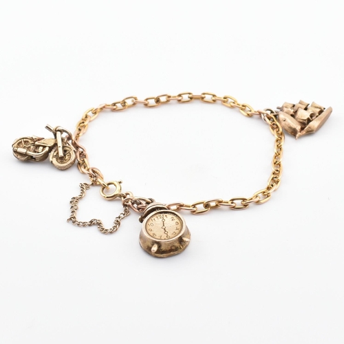 70 - A hallmarked 9ct gold charm bracelet. The bracelet strung with three yellow metal charms including a... 