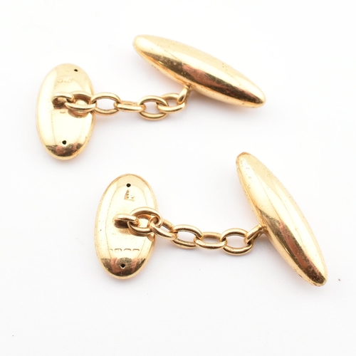 71 - A pair of hallmarked gold torpedo cufflinks. The cufflinks having torpedo heads united by chain. Par... 