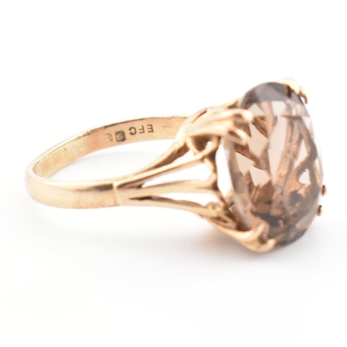 74 - A 9ct gold and smoky quartz cocktail ring. The ring set with a claw mounted smoky quartz in a pierce... 