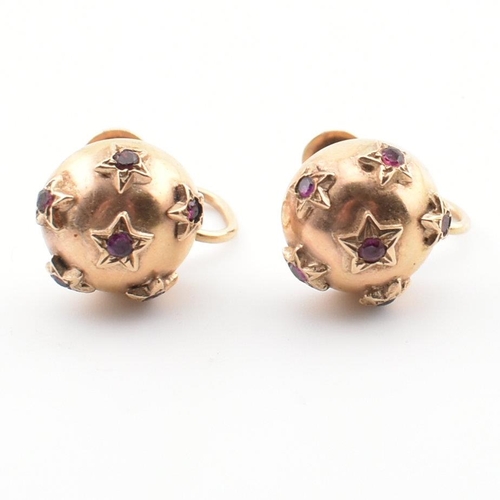 77 - A pair of hallmarked 9ct gold and ruby domed screw back earrings. Hallmarked for Chester, 1954. Earr... 