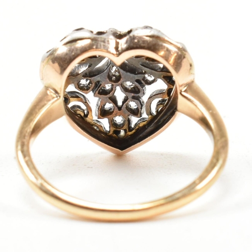 8 - A Victorian pierced diamond heart ring. The Art Nouveau ring having a pierced old cut diamond set he... 