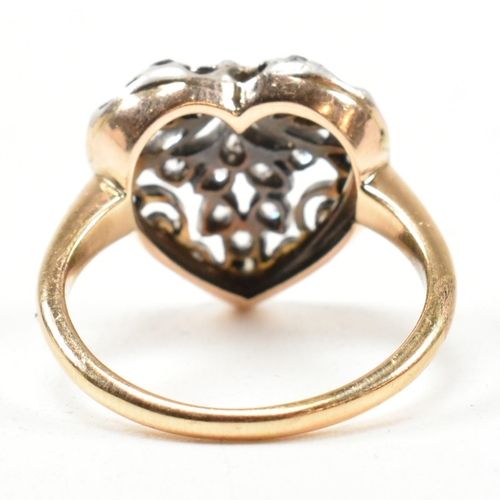 8 - A Victorian pierced diamond heart ring. The Art Nouveau ring having a pierced old cut diamond set he... 