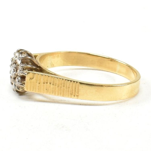 80 - An 18ct gold and diamond cluster ring. The ring set with eight round brilliant cut diamonds with bar... 