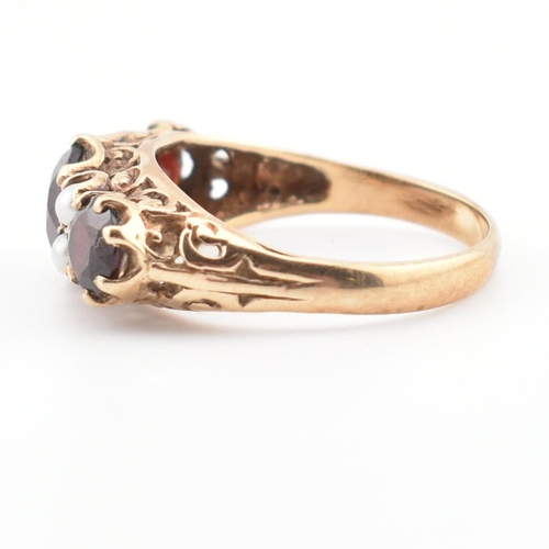 83 - A hallmarked 9ct gold, garnet and pearl three stone ring. The ring having three round mixed cut garn... 