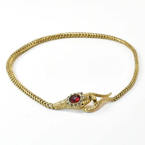 88 - A late Victorian/early Edwardian gilt metal and paste snake necklace. The necklace in the form of an... 