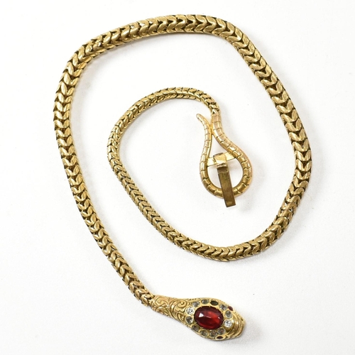 88 - A late Victorian/early Edwardian gilt metal and paste snake necklace. The necklace in the form of an... 