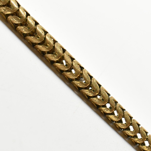 88 - A late Victorian/early Edwardian gilt metal and paste snake necklace. The necklace in the form of an... 