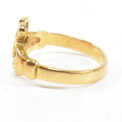 89 - An 18ct gold Claddagh ring. The Irish Claddagh ring bearing Egyptian hallmarks for 18ct gold. Size I... 