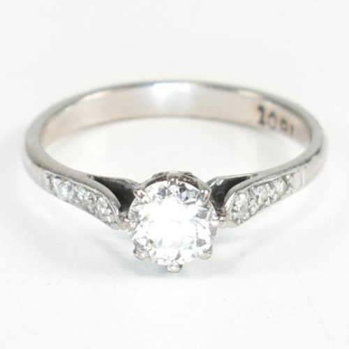 91 - An 18ct white gold and diamond solitaire ring. The ring having a central eight claw set round brilli... 