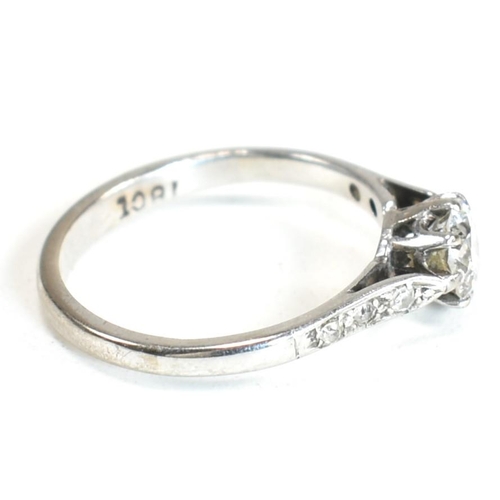 91 - An 18ct white gold and diamond solitaire ring. The ring having a central eight claw set round brilli... 