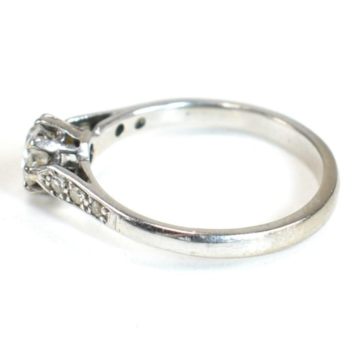 91 - An 18ct white gold and diamond solitaire ring. The ring having a central eight claw set round brilli... 