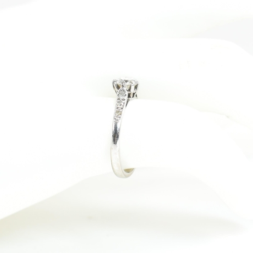 91 - An 18ct white gold and diamond solitaire ring. The ring having a central eight claw set round brilli... 