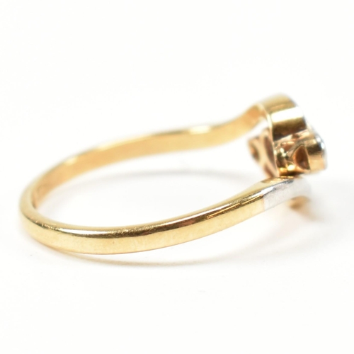 95 - An 18ct gold, diamond and sapphire crossover ring. The ring having a central bezel set round cut dia... 