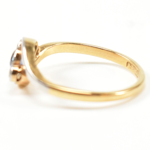 95 - An 18ct gold, diamond and sapphire crossover ring. The ring having a central bezel set round cut dia... 