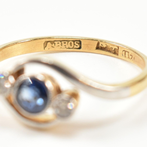 95 - An 18ct gold, diamond and sapphire crossover ring. The ring having a central bezel set round cut dia... 