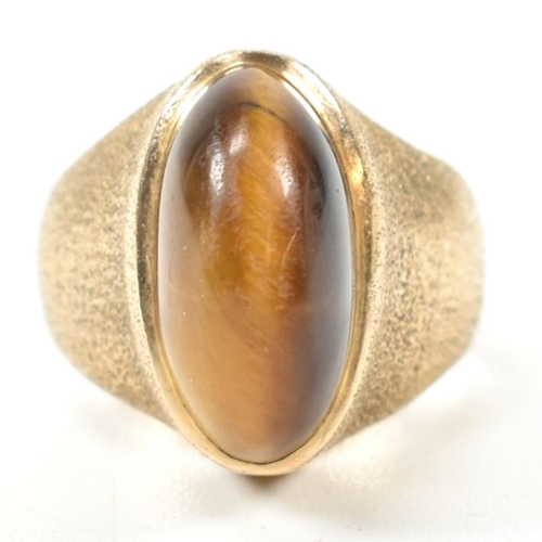 15A - A hallmarked 9ct 1970s gold and tigers eye modernist ring. The ring by the Albion Crafts Company set... 