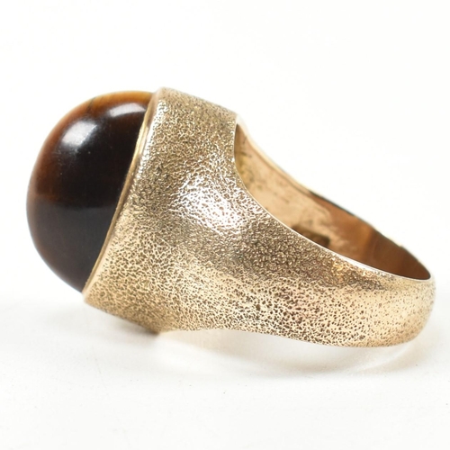 15A - A hallmarked 9ct 1970s gold and tigers eye modernist ring. The ring by the Albion Crafts Company set... 