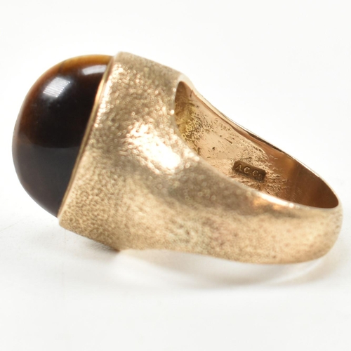 15A - A hallmarked 9ct 1970s gold and tigers eye modernist ring. The ring by the Albion Crafts Company set... 