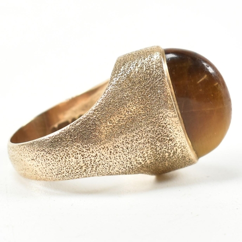 15A - A hallmarked 9ct 1970s gold and tigers eye modernist ring. The ring by the Albion Crafts Company set... 