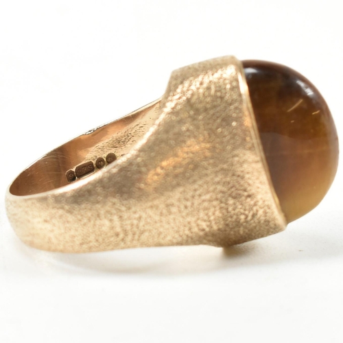 15A - A hallmarked 9ct 1970s gold and tigers eye modernist ring. The ring by the Albion Crafts Company set... 