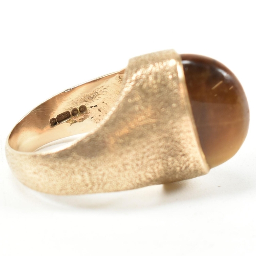 15A - A hallmarked 9ct 1970s gold and tigers eye modernist ring. The ring by the Albion Crafts Company set... 