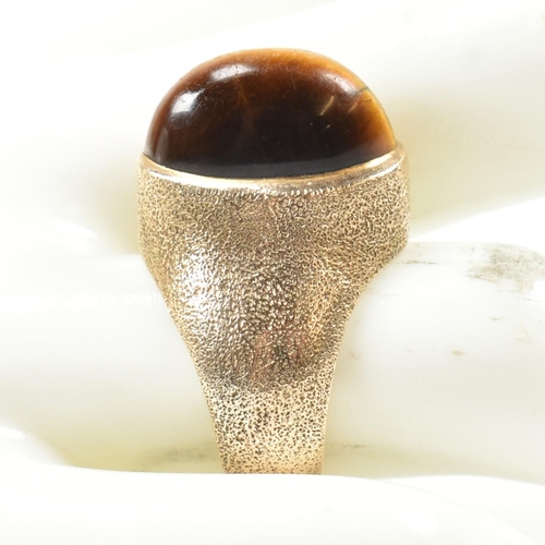 15A - A hallmarked 9ct 1970s gold and tigers eye modernist ring. The ring by the Albion Crafts Company set... 