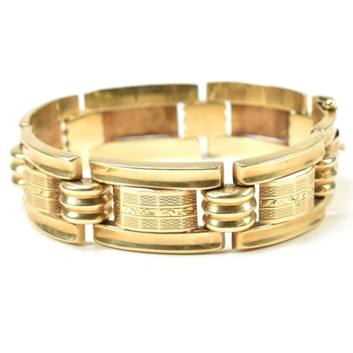 31 - A 14ct gold yellow gold bracelet. The bracelet formed with rectangular tank style links with etched ... 