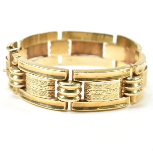 31 - A 14ct gold yellow gold bracelet. The bracelet formed with rectangular tank style links with etched ... 