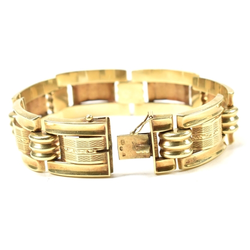 31 - A 14ct gold yellow gold bracelet. The bracelet formed with rectangular tank style links with etched ... 