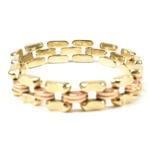 39A - A 14ct bi colour gold bracelet. The bracelet formed with concave and fluted links in yellow and rose... 