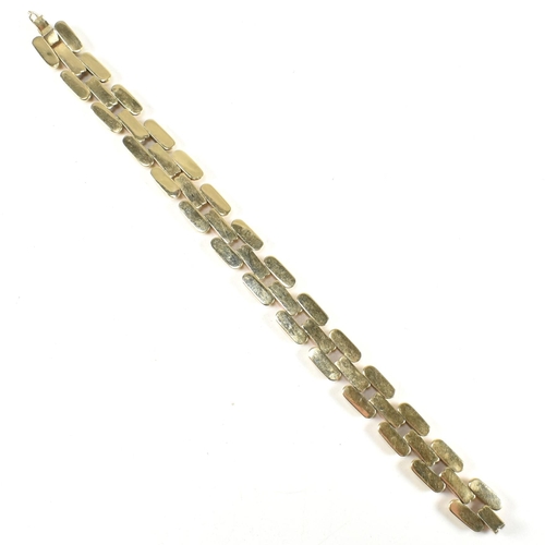 39A - A 14ct bi colour gold bracelet. The bracelet formed with concave and fluted links in yellow and rose... 