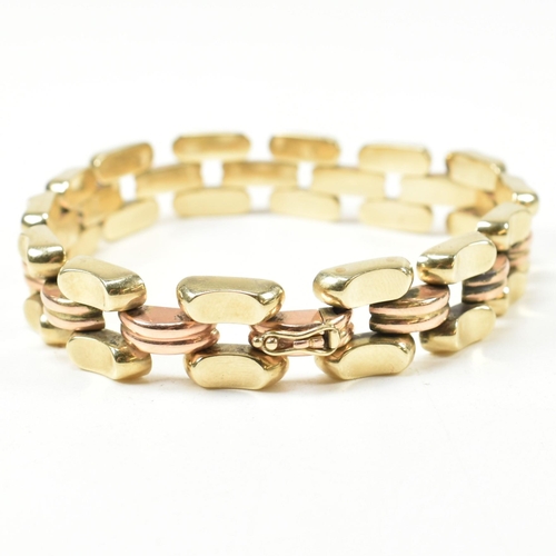 39A - A 14ct bi colour gold bracelet. The bracelet formed with concave and fluted links in yellow and rose... 