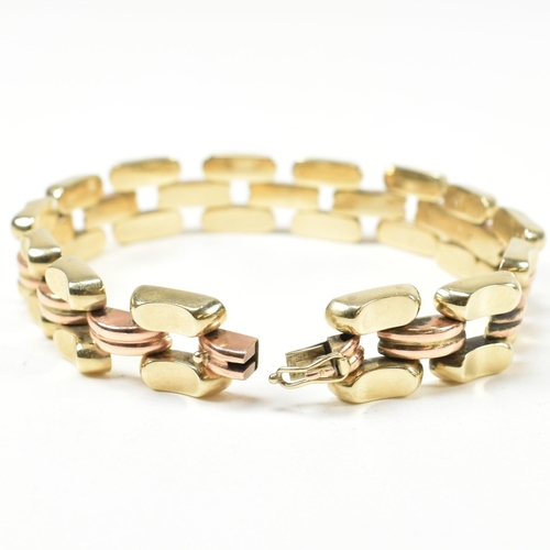 39A - A 14ct bi colour gold bracelet. The bracelet formed with concave and fluted links in yellow and rose... 