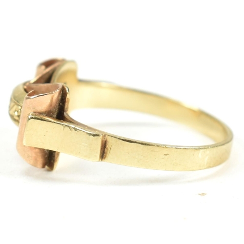 45A - A 14ct gold retro ring. The ring having a scrolled and etched decorated bi colour gold head to plain... 