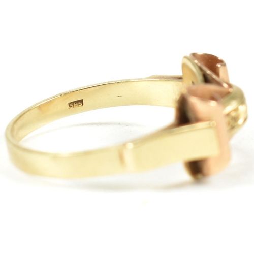 45A - A 14ct gold retro ring. The ring having a scrolled and etched decorated bi colour gold head to plain... 