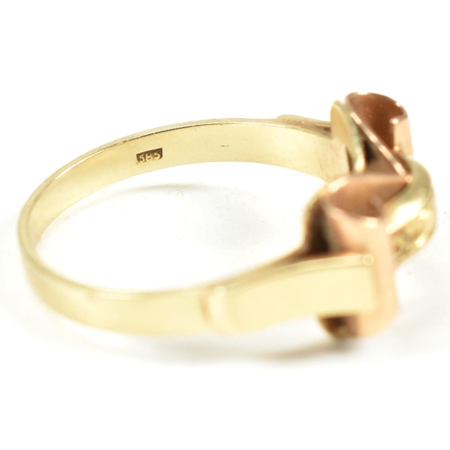 45A - A 14ct gold retro ring. The ring having a scrolled and etched decorated bi colour gold head to plain... 