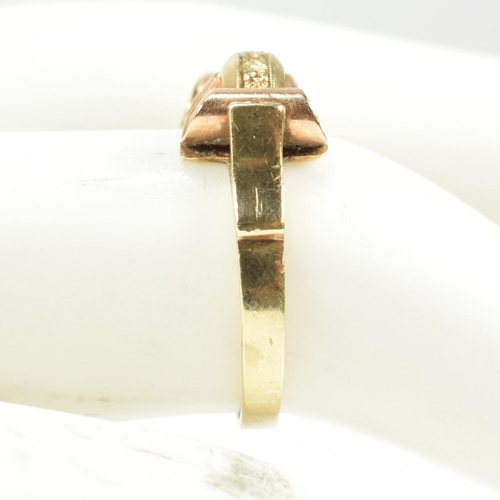 45A - A 14ct gold retro ring. The ring having a scrolled and etched decorated bi colour gold head to plain... 