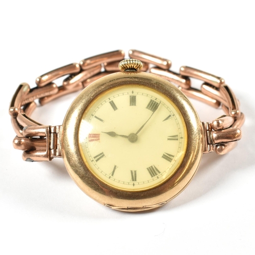 56a - A 9ct gold 15 jewel wrist watch on a 9ct gold expanding bracelet strap. The watch having a white dia... 