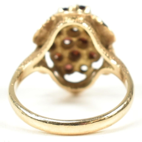 58A - A hallmarked 9ct gold and garnet cluster ring. The ring set with a cluster of round mixed cut garnet... 