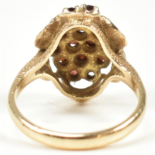 58A - A hallmarked 9ct gold and garnet cluster ring. The ring set with a cluster of round mixed cut garnet... 