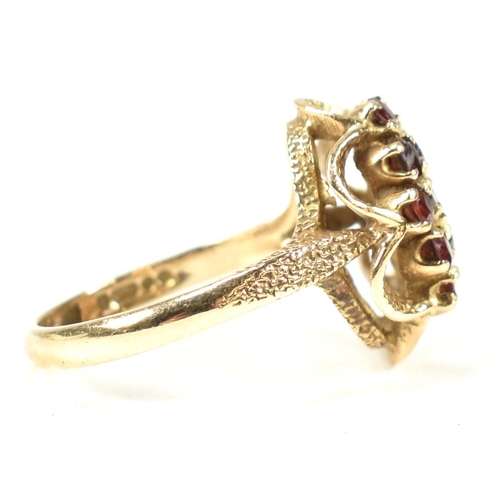 58A - A hallmarked 9ct gold and garnet cluster ring. The ring set with a cluster of round mixed cut garnet... 