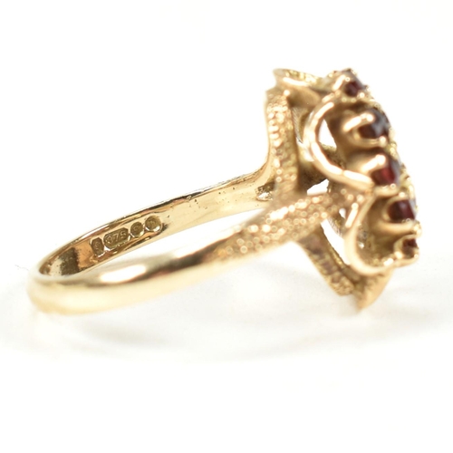 58A - A hallmarked 9ct gold and garnet cluster ring. The ring set with a cluster of round mixed cut garnet... 