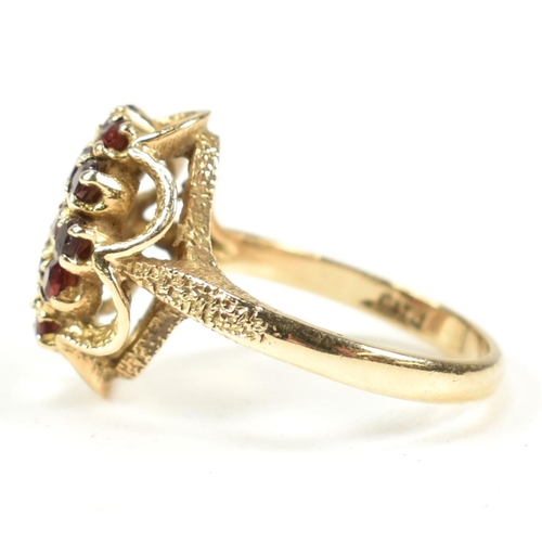 58A - A hallmarked 9ct gold and garnet cluster ring. The ring set with a cluster of round mixed cut garnet... 