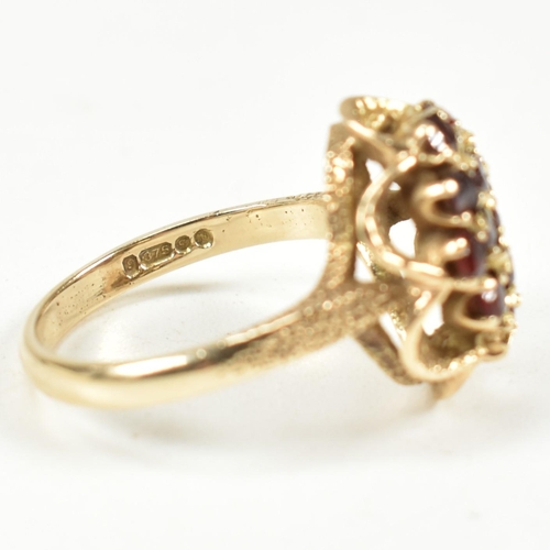 58A - A hallmarked 9ct gold and garnet cluster ring. The ring set with a cluster of round mixed cut garnet... 