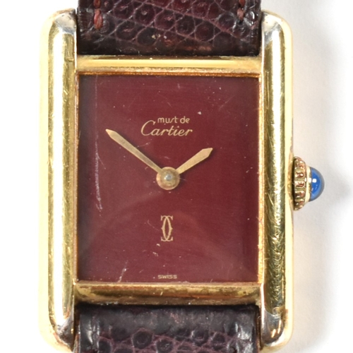 31A - Vintage Must De Cartier tank watch . The watch having a rectangular burgundy dial in a gold plated s... 